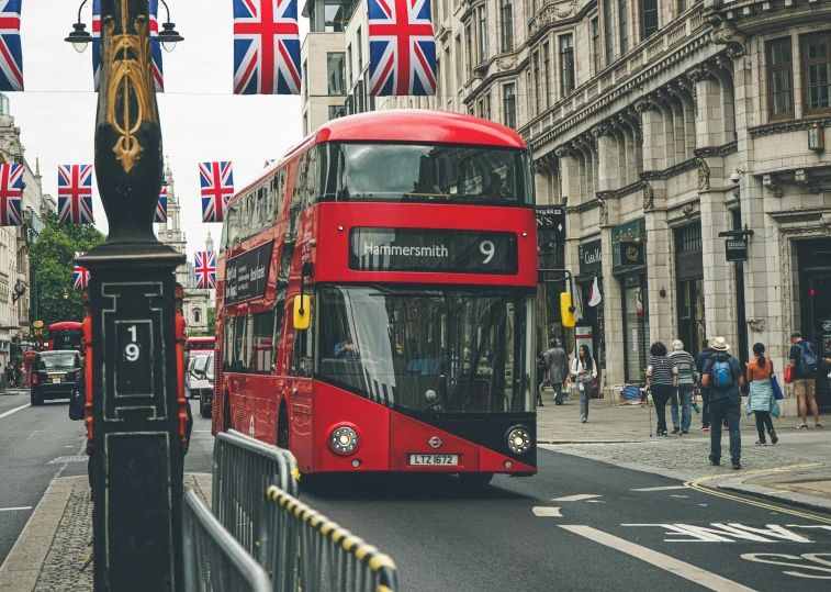 a double decker bus is traveling on the street