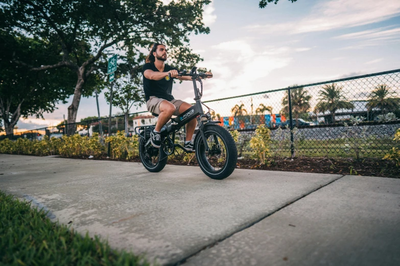 a person on a small bike next to a fence