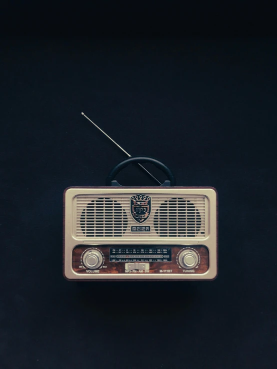 a small radio on top of a black table