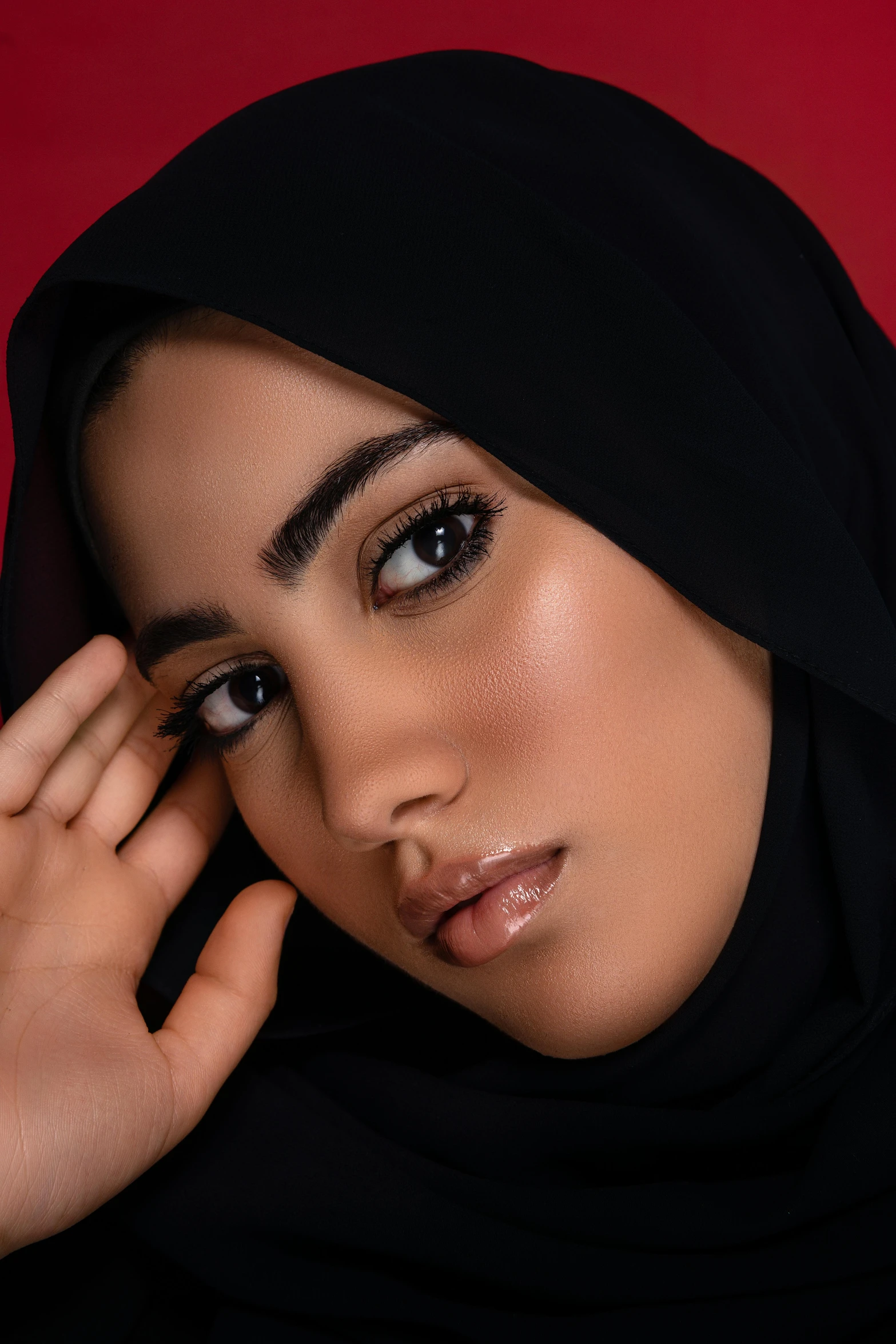 a close up of a person wearing a black head scarf