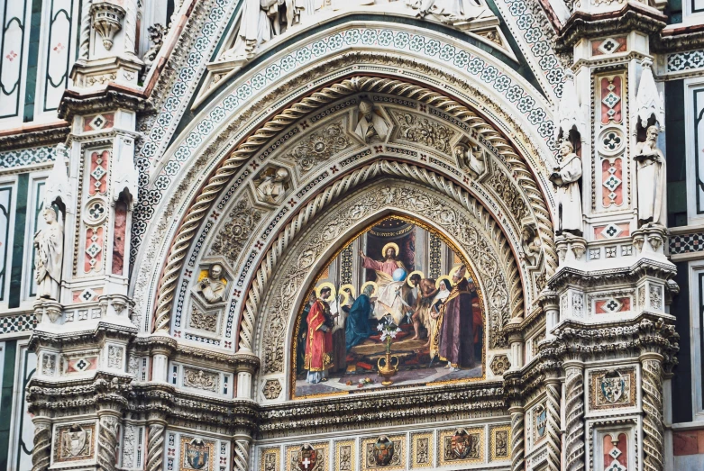 the painting above the ornate doorway is of religious people