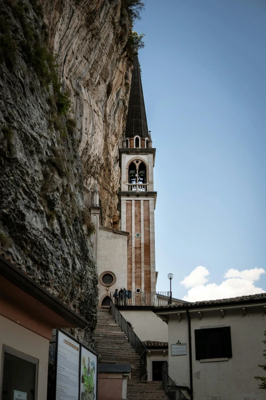 a tower with a clock is near a small church