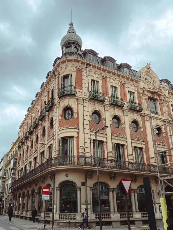 a brown building sits near the street corner