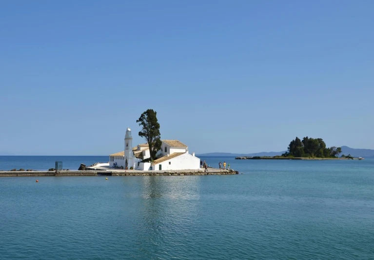 an island on the ocean with a house on top