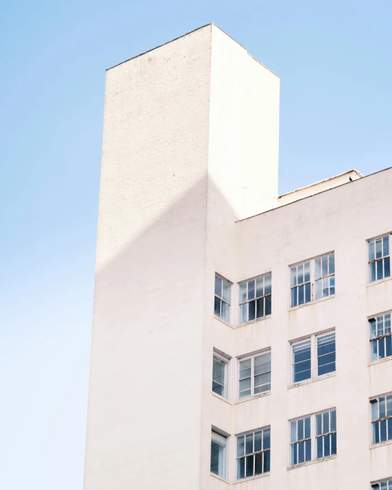 a building's top and side windows with a sky background