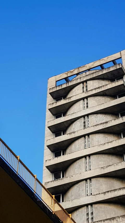 an angled view of a tall building with metal railing