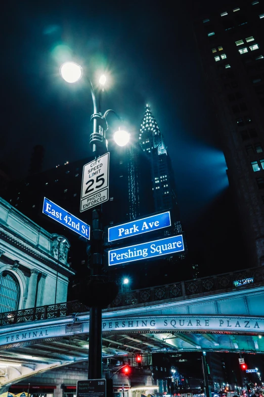 the city street signs are lit up with street lights