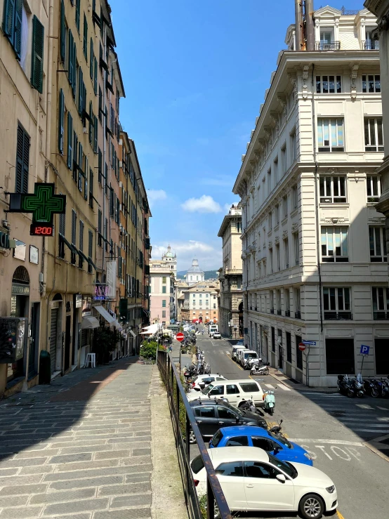 a narrow street has traffic passing by in the city