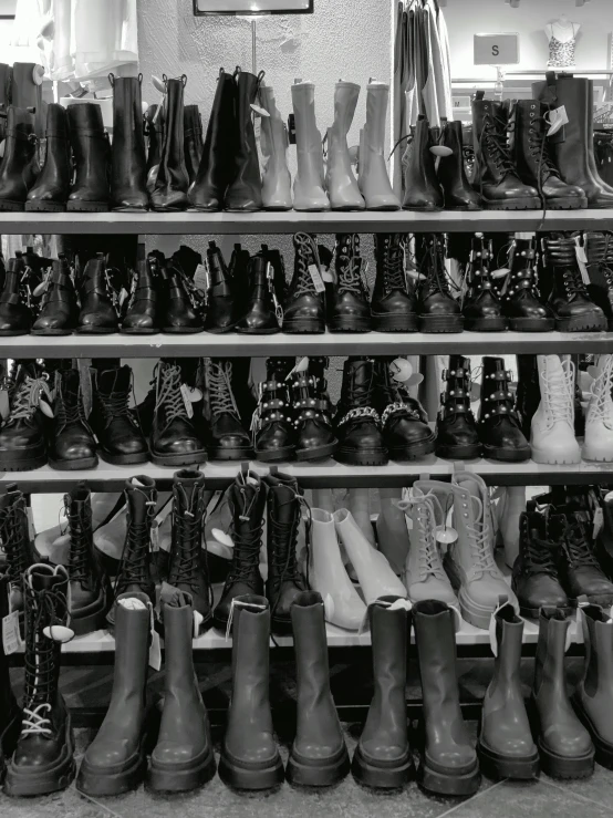 lots of different kinds and sizes of shoes are displayed on shelves