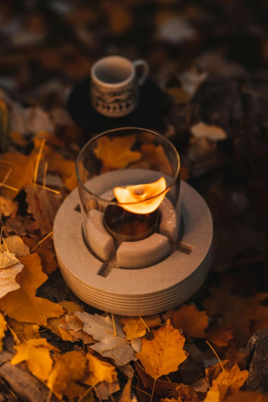 there is a small glass candle on the coaster