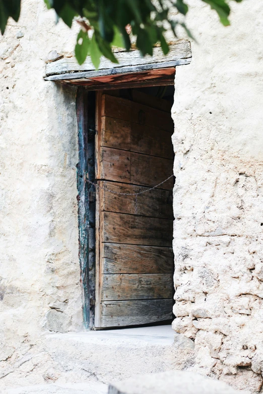 a door on the side of a stone building