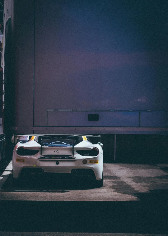 two cars sitting beside each other in the dark