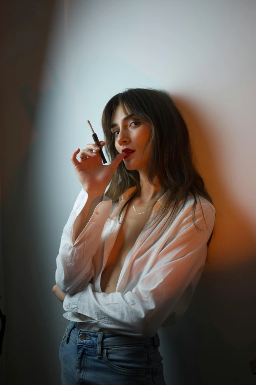 a young woman smokes on the phone in the dark