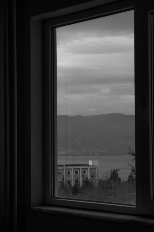 a window view looking out to water and mountains