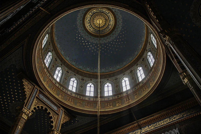 the dome of the building is adorned with gold and black decor