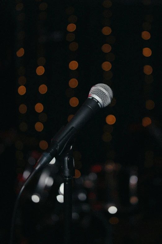 a microphone is sitting in front of some light up lights