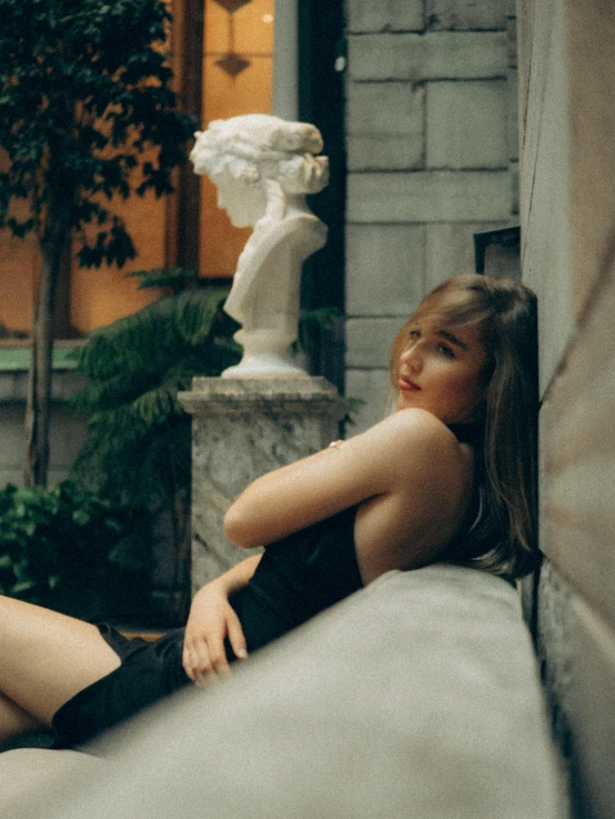 a pretty young lady sitting on top of a couch