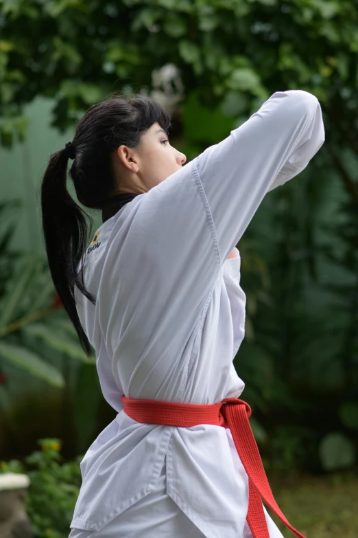 a woman who is wearing a kimono pointing upward