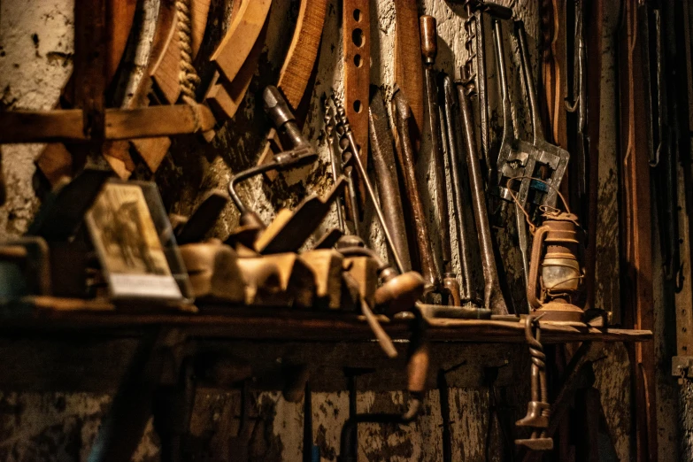 wood and metal tools hang from a wooden rack