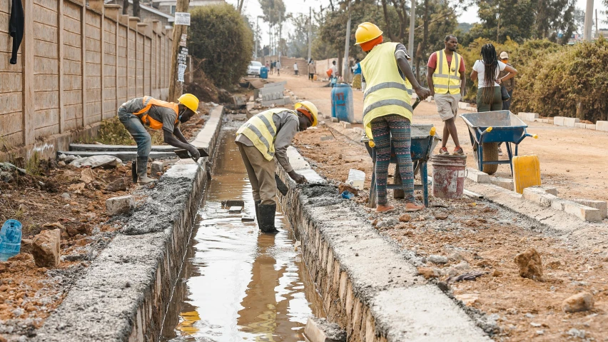 some construction workers building a wall with cement