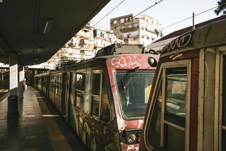 train on tracks next to building in urban area