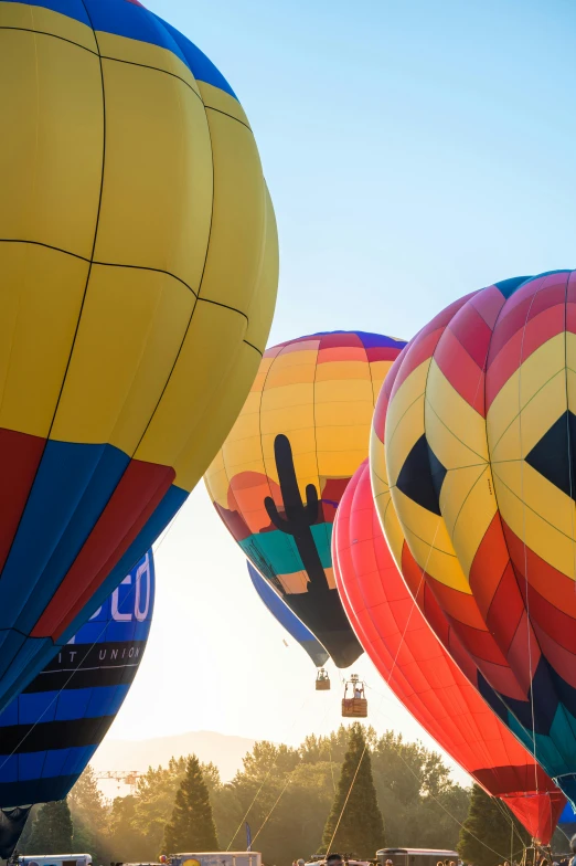 several large  air balloons with the colors red, yellow and blue