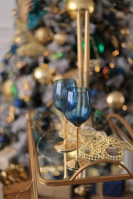 two blue glasses are sitting on a glass tray