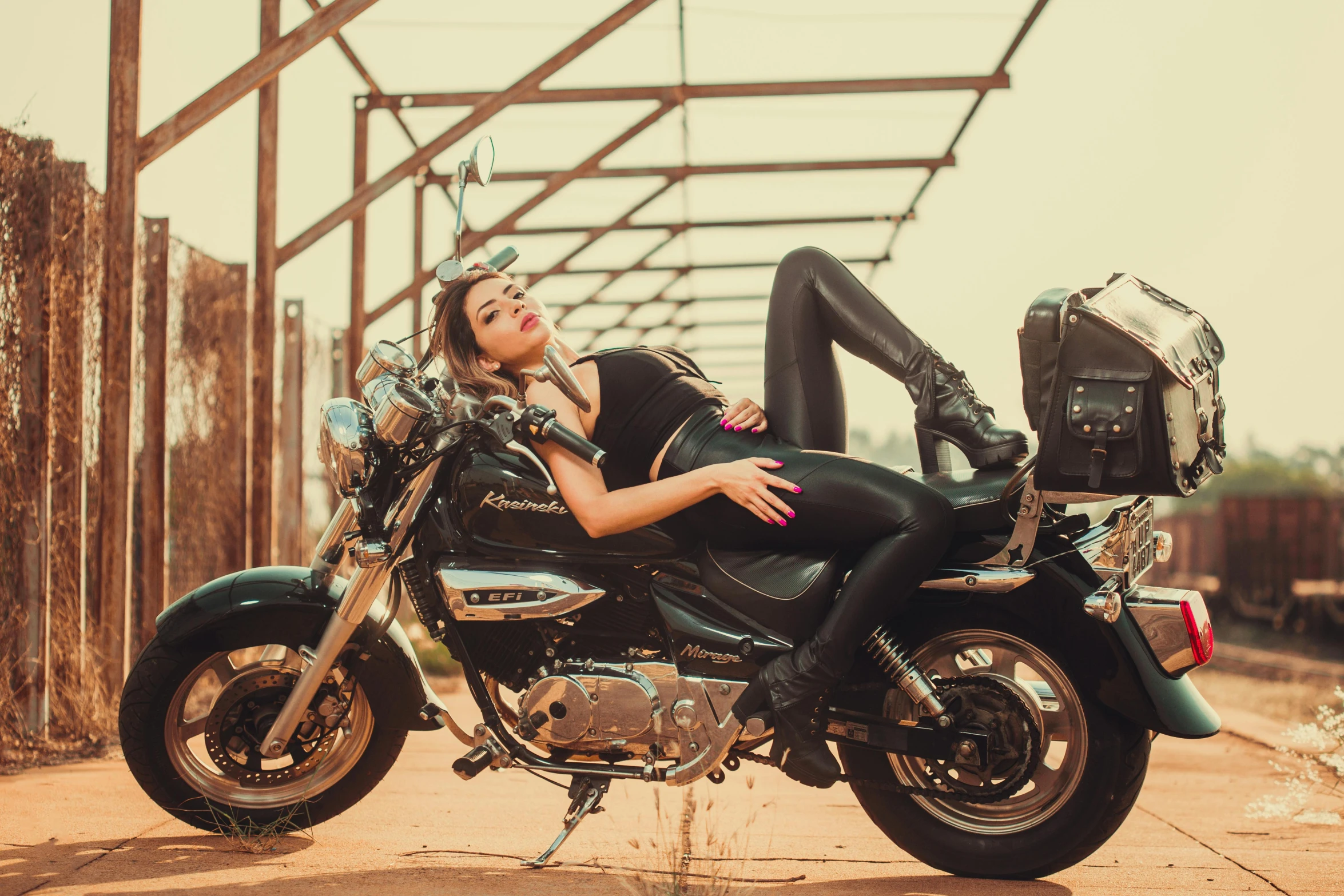 a woman is laying on her motorcycle