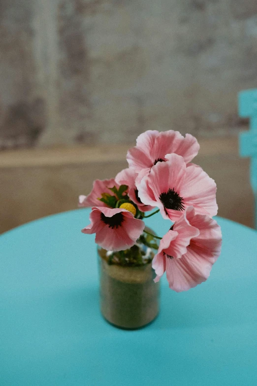 two pink flowers in vase on table