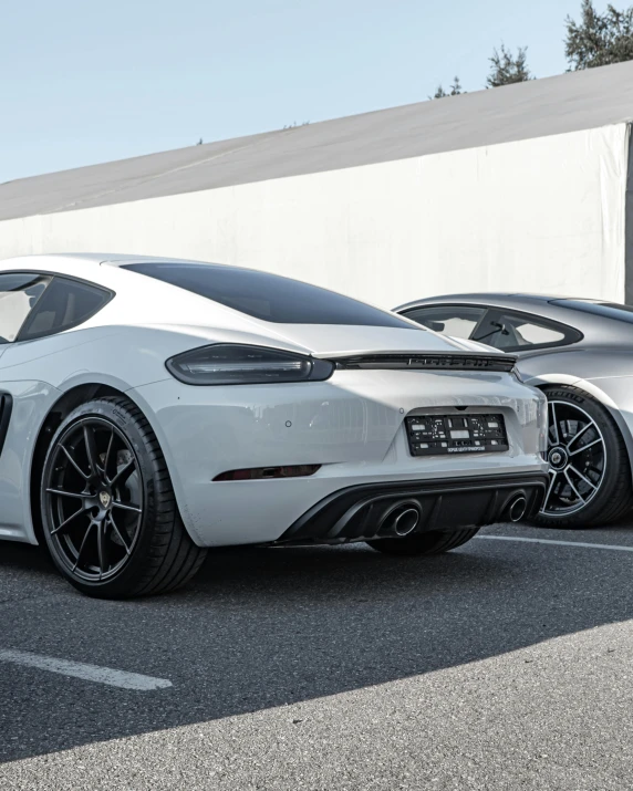 a white and black car is parked in the street