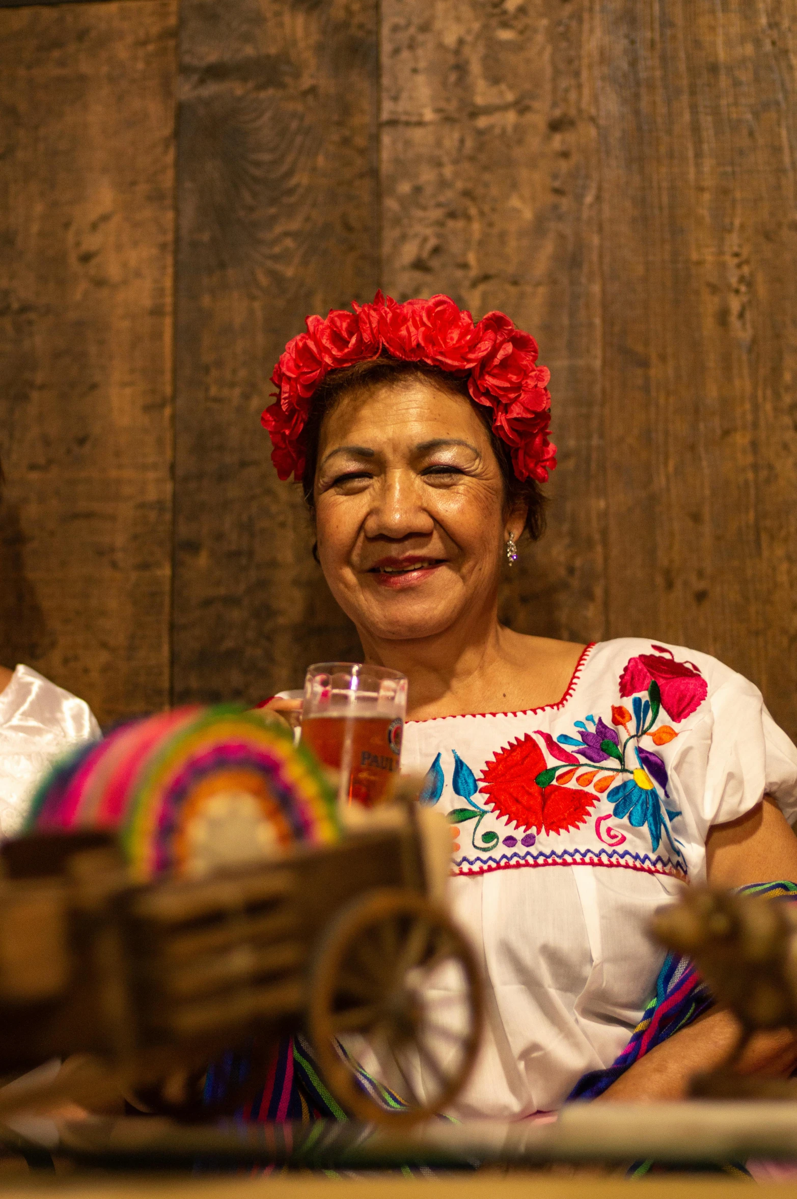 an older woman smiles at a man while he makes mexican food