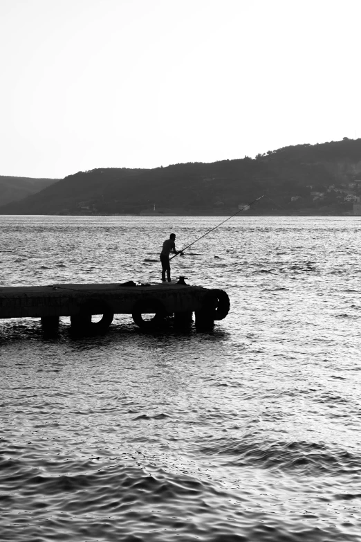 a person standing on top of a wooden pier