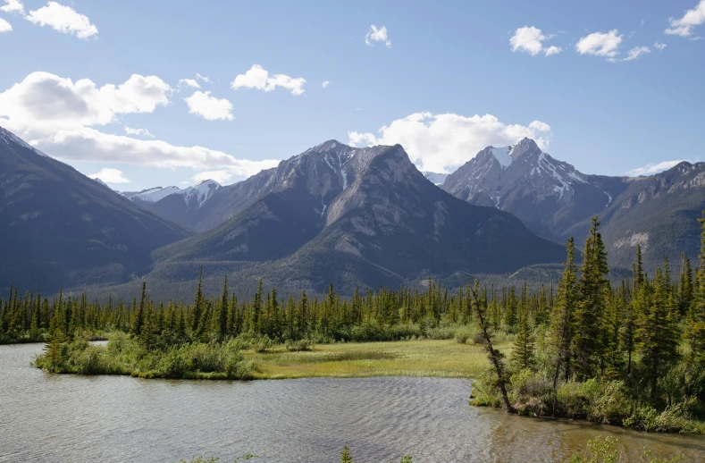 a body of water in front of a mountain range