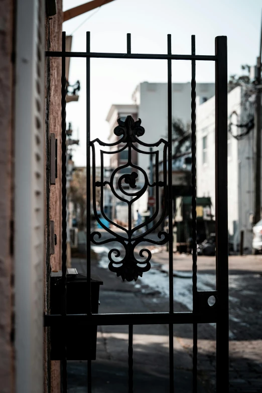 an iron gate at the entrance to a street