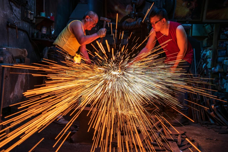 two people with large sparks in front of a group of other items