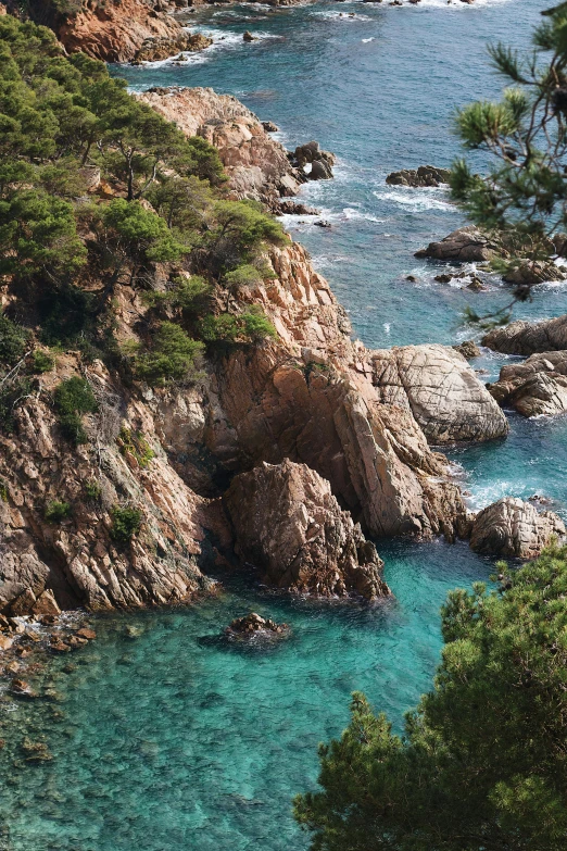 a view of the sea and rocks at a beach