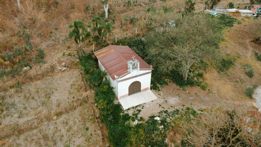 an aerial view shows the remains of a small, white chapel