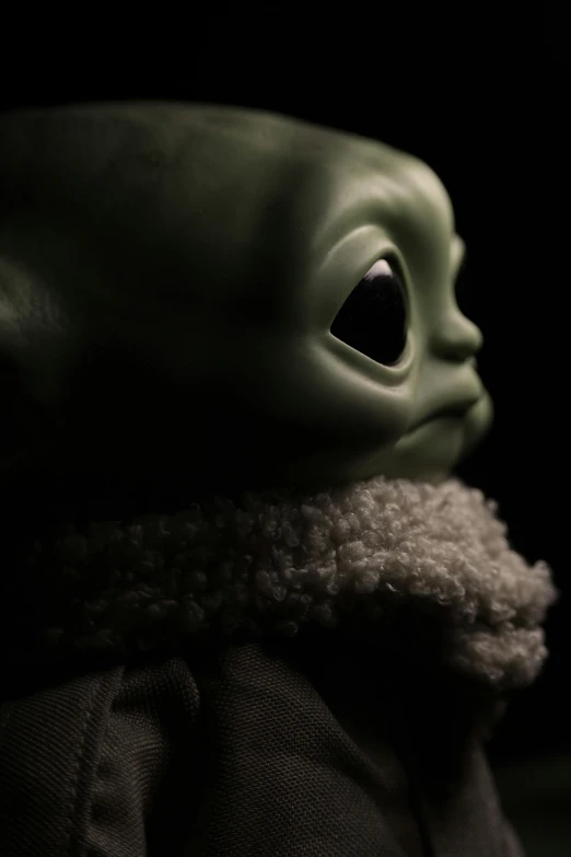 an adorable, young baby yoda doll is shown in black and white