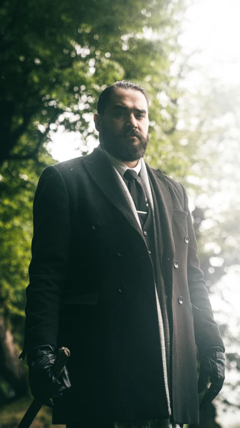 a man is standing outside in a suit and tie