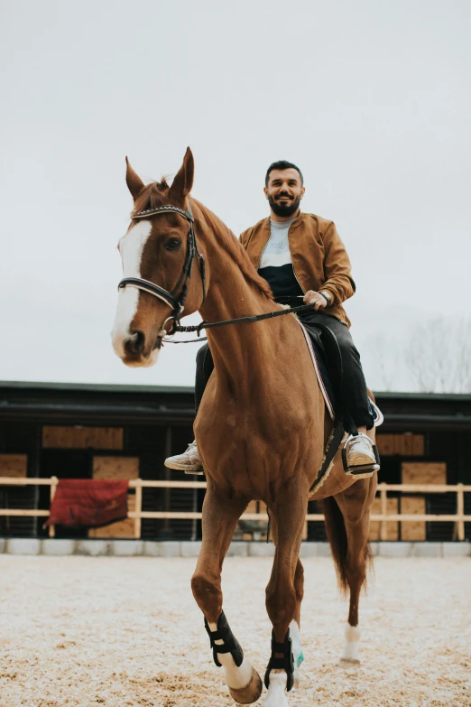 a man riding a horse while wearing a brown jacket