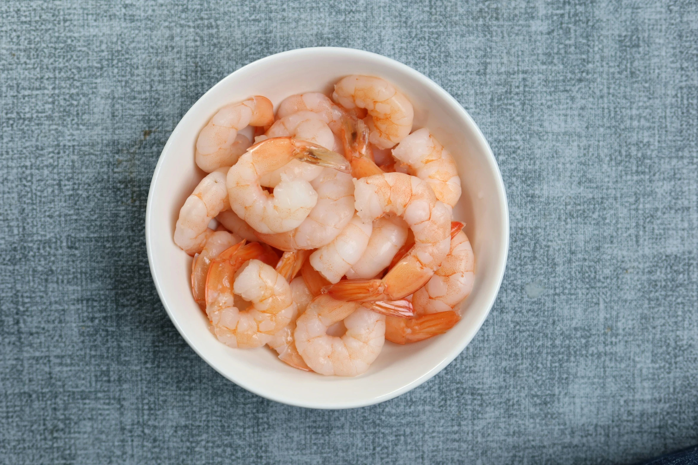 a white bowl of shrimp with no crust on the top