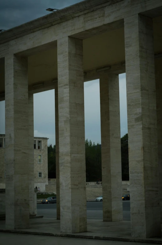 some concrete pillars with cars in the background