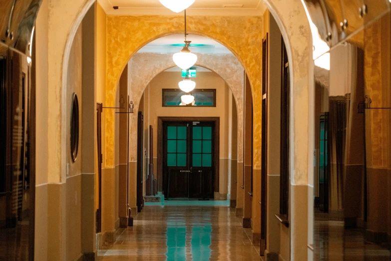 a hallway is lined with lights and doors