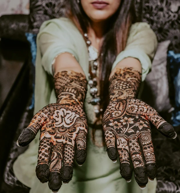 a woman with hands decorated with henna