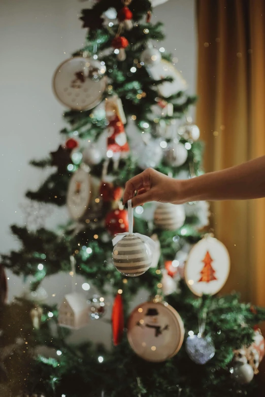 a white christmas tree with ornaments hanging from it