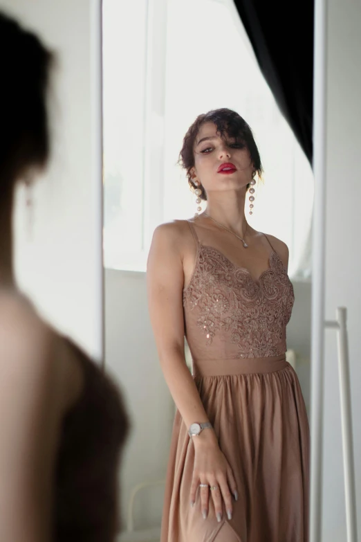 a woman looks in the mirror at her dress