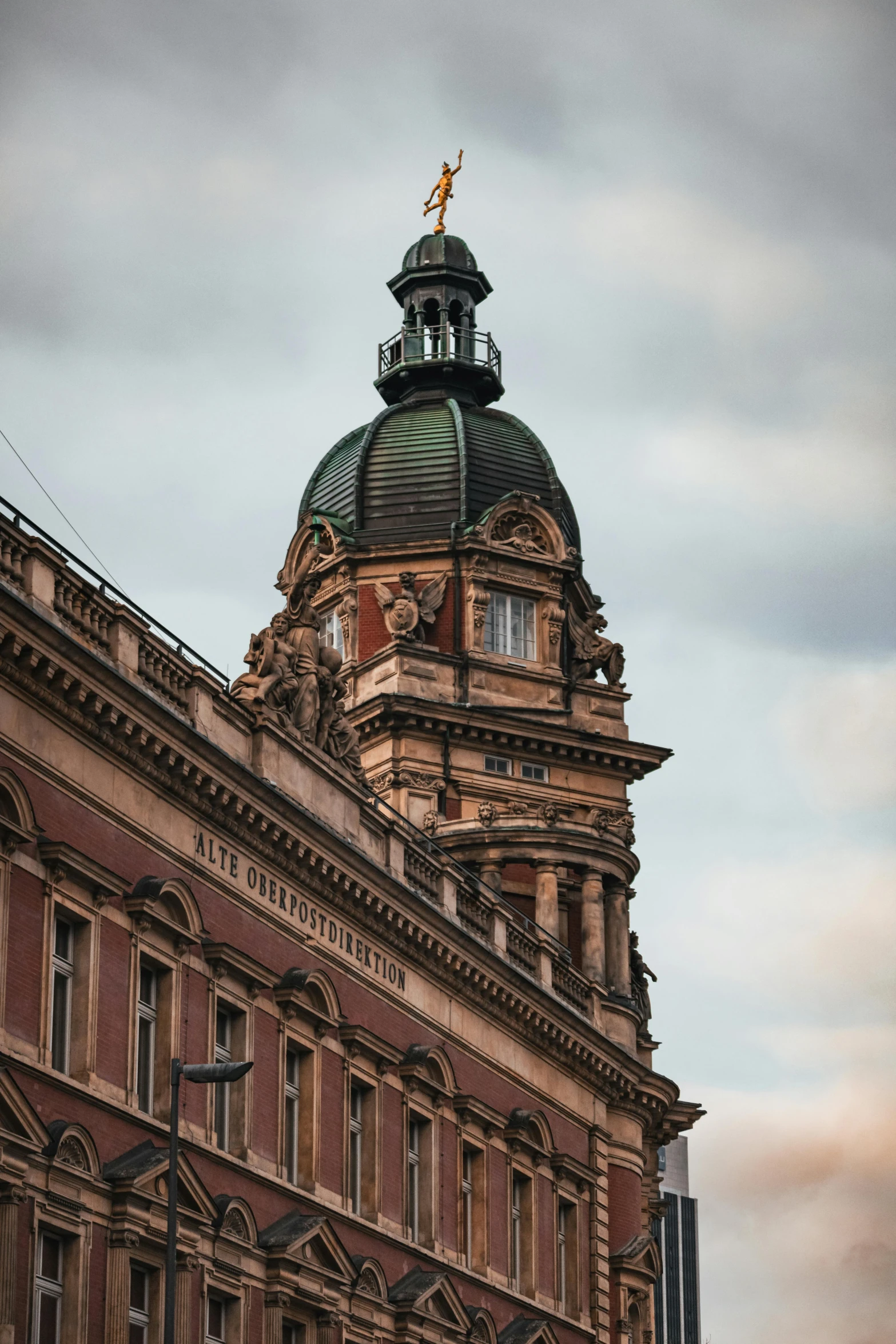 large brown building with a small cross on top