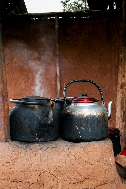 pots and kettles set out on top of a table