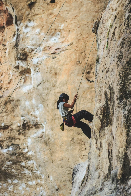 a person is climbing up a very steep mountain