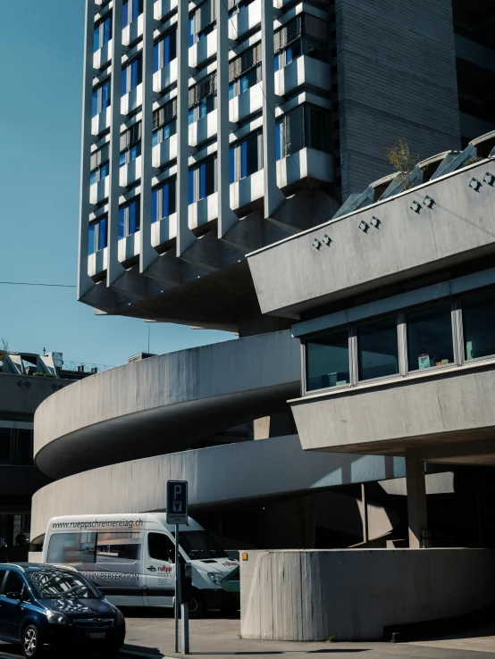 a parking lot with cars parked in front of buildings